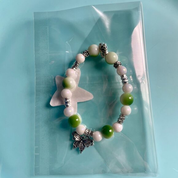 Handmade bracelet with beads and dangling butterfly charm - Picture 3 of 9